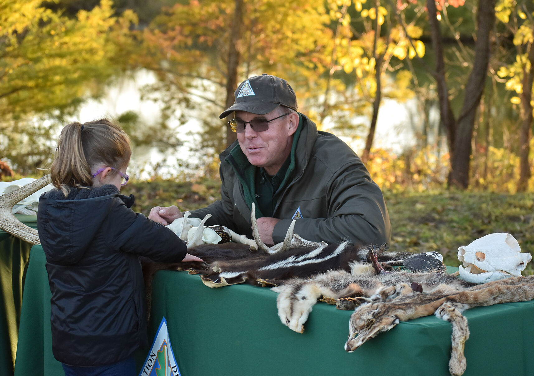 Dwight Warnke shows Clara Cole, 4, animal skeletons and pellets